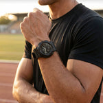 Person wearing a black watch on a sports field