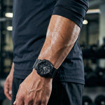Person wearing a black watch on a gym setting