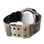 Close-up of G-shock GA100L-8A watch with a beige strap and metallic buckle on a white background