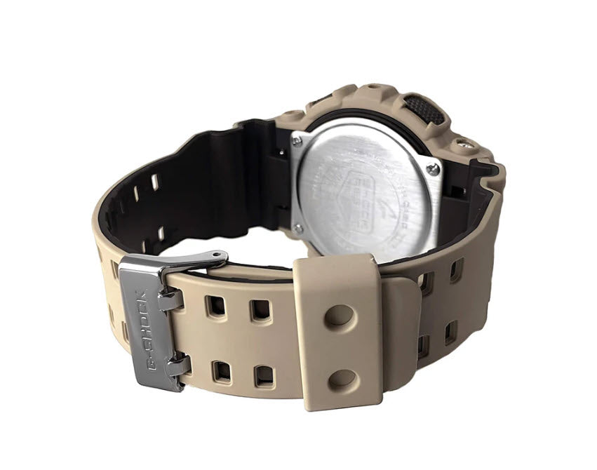 Close-up of G-shock GA100L-8A watch with a beige strap and metallic buckle on a white background