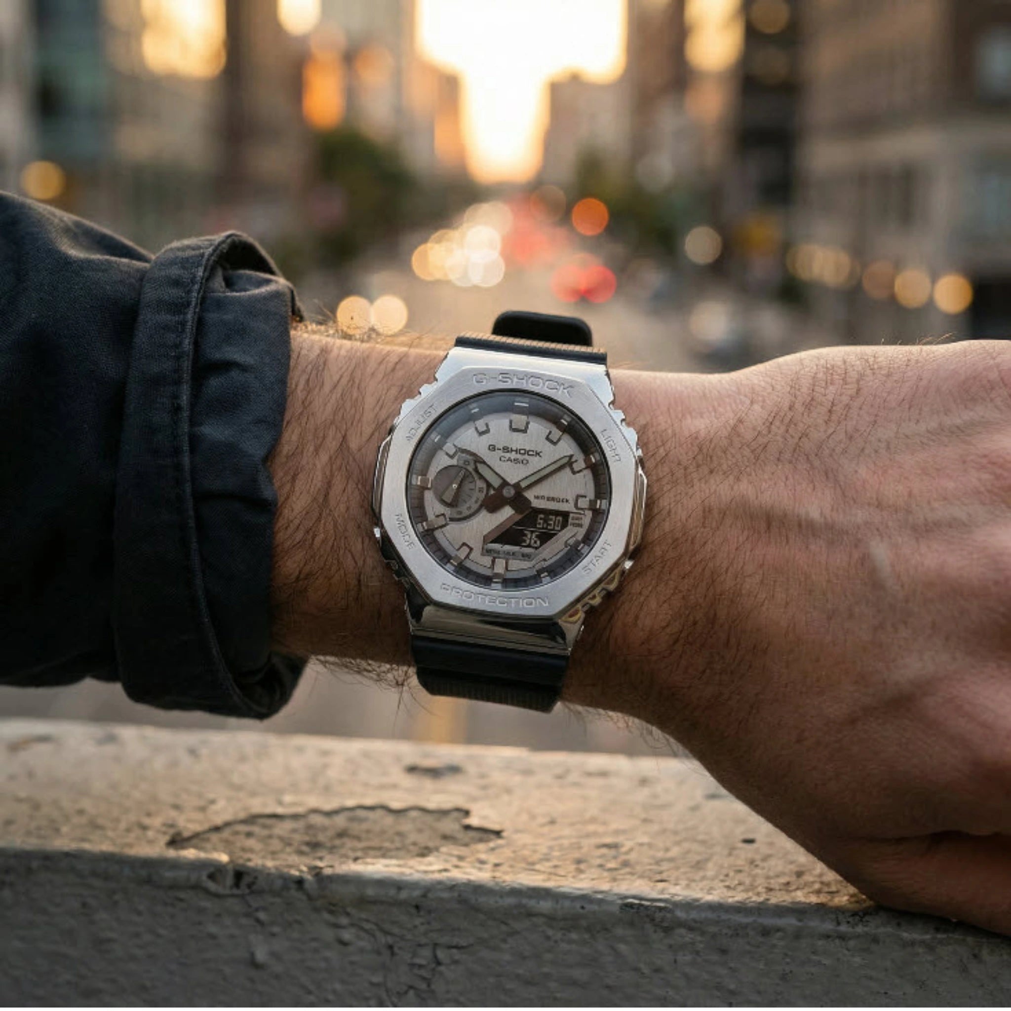 Person wearing a Casio watch with a cityscape background
