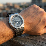 Close-up of a person's wrist wearing a Casio G-Shock watch with a blurred background