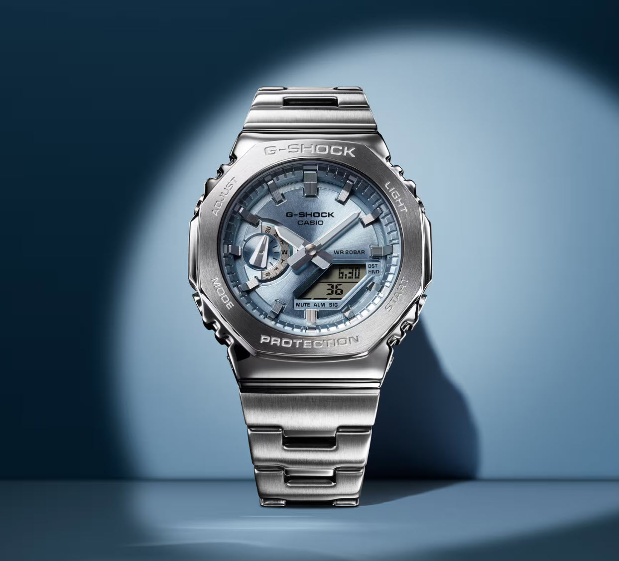 Silver Casio G-Shock watch on a blue gradient background
