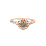 A rose gold engagement ring with a central chocolate diamond and accenting white round diamonds.