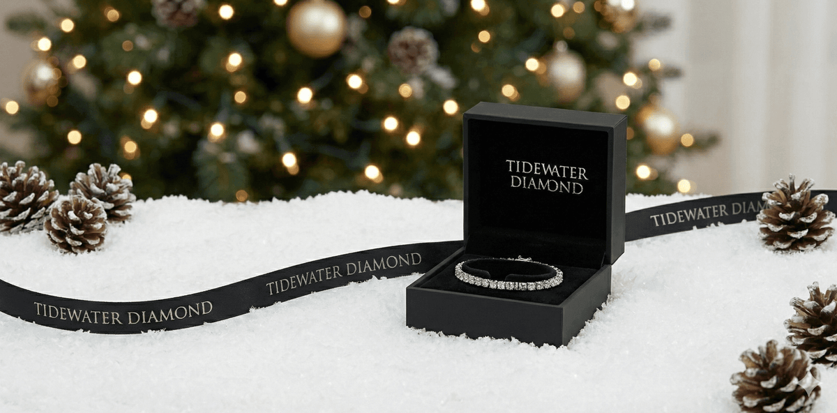Tidewater Diamond jewelry box with bracelet on a snowy surface with Christmas tree in the background